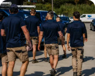 Plumbers walking to their service vans on a Burwood Heights job